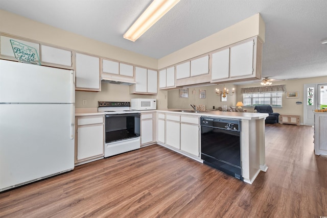 613 S 2nd Ave Unit 21D, North Myrtle Beach, SC 29582 - kitchen with white appliances, wood finished floors, open floor plan, under cabinet range hood, and white cabinets