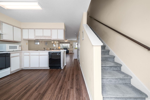 613 S 2nd Ave Unit 21D, North Myrtle Beach, SC 29582 - kitchen featuring black dishwasher, dark wood-style floors, white microwave, white cabinetry, and light countertops