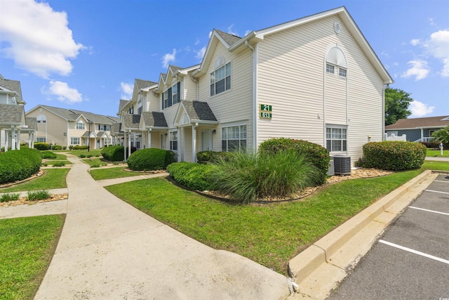 613 S 2nd Ave Unit 21D, North Myrtle Beach, SC 29582 - view of side of home with a residential view, uncovered parking, central AC, and a lawn