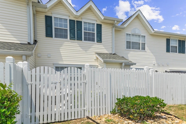 613 S 2nd Ave Unit 21D, North Myrtle Beach, SC 29582 - view of side of property featuring a gate and roof with shingles