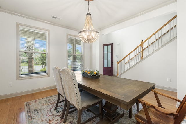 18 Cyclamen Ct, Murrells Inlet, SC 29576 - dining space featuring a chandelier, wood finished floors, ornamental molding, stairs, and baseboards