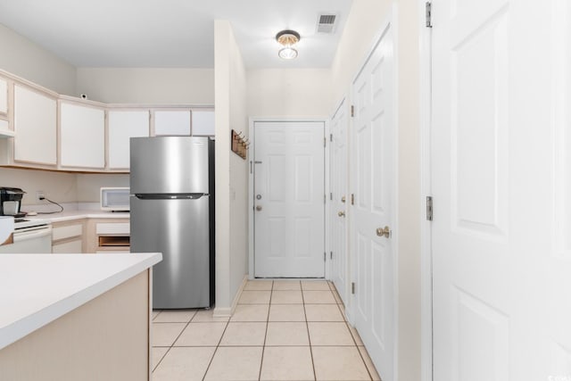 1298 River Oaks Dr Unit 5-I, Myrtle Beach, SC 29579 - kitchen featuring white appliances, light countertops, light tile patterned floors, and white cabinetry