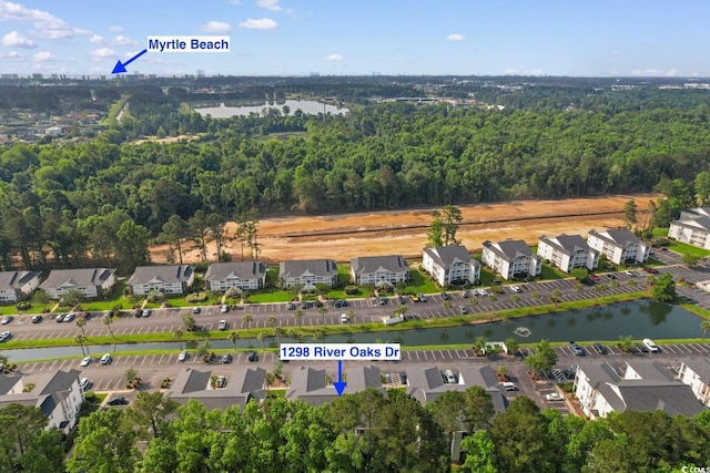 1298 River Oaks Dr Unit 5-I, Myrtle Beach, SC 29579 - aerial view of property's location featuring a large body of water, a forest, and nearby suburban area