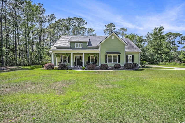 769 Country Club Dr, Pawleys Island, SC 29585 - view of front of property featuring a porch, metal roof, a front lawn, and a standing seam roof