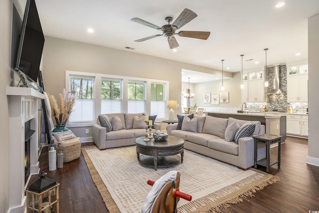 769 Country Club Dr, Pawleys Island, SC 29585 - living area featuring recessed lighting, dark wood-style flooring, a ceiling fan, a warm lit fireplace, and baseboards