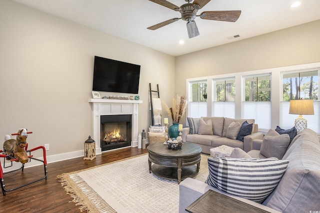 769 Country Club Dr, Pawleys Island, SC 29585 - living area with recessed lighting, ceiling fan, dark wood-type flooring, a warm lit fireplace, and baseboards