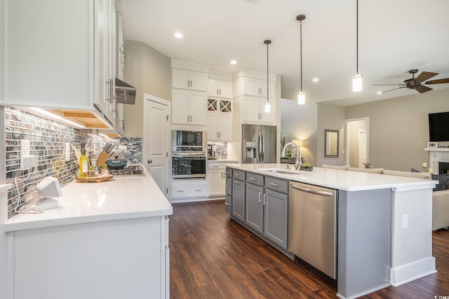 769 Country Club Dr, Pawleys Island, SC 29585 - kitchen featuring appliances with stainless steel finishes, gray cabinetry, ceiling fan, open floor plan, and decorative backsplash