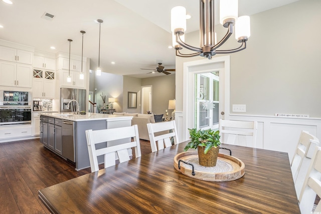 769 Country Club Dr, Pawleys Island, SC 29585 - dining room with ceiling fan, a chandelier, wainscoting, recessed lighting, and dark wood-style flooring