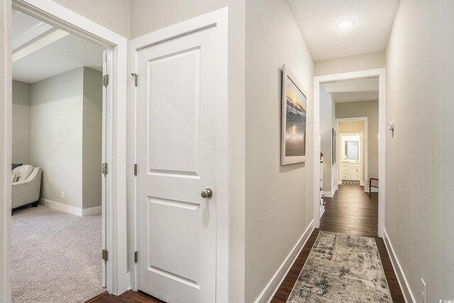 769 Country Club Dr, Pawleys Island, SC 29585 - hall with baseboards, dark wood-style flooring, and a baseboard radiator