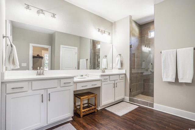 769 Country Club Dr, Pawleys Island, SC 29585 - bathroom featuring double vanity, a stall shower, wood finished floors, and baseboards