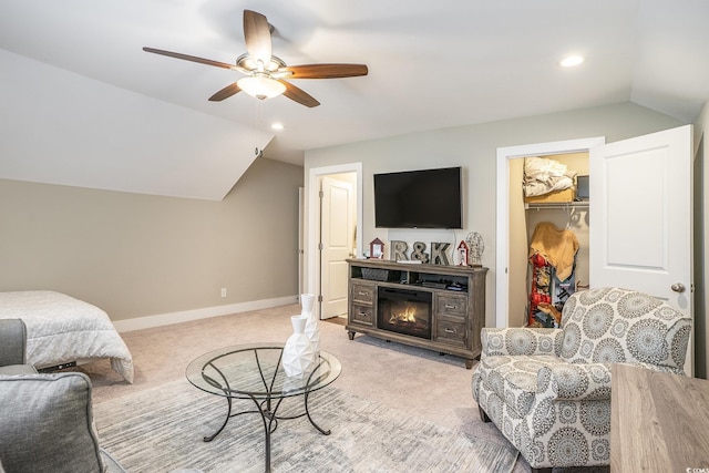 769 Country Club Dr, Pawleys Island, SC 29585 - living room with lofted ceiling, light colored carpet, ceiling fan, a glass covered fireplace, and baseboards