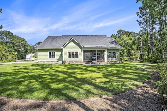 769 Country Club Dr, Pawleys Island, SC 29585 - back of property featuring a sunroom, a yard, and metal roof