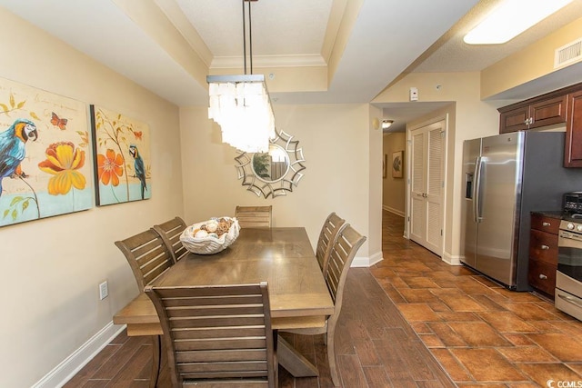 100 N Beach Blvd Unit 1511, North Myrtle Beach, SC 29582 - dining space with ornamental molding, baseboards, a chandelier, a tray ceiling, and dark wood finished floors