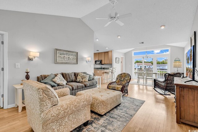 521 Bay Dr, Garden City Beach, SC 29576 - living room with a ceiling fan, light wood finished floors, and high vaulted ceiling