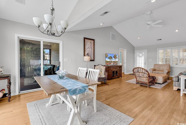 521 Bay Dr, Garden City Beach, SC 29576 - dining space featuring light wood-style floors, high vaulted ceiling, a ceiling fan, a chandelier, and baseboards