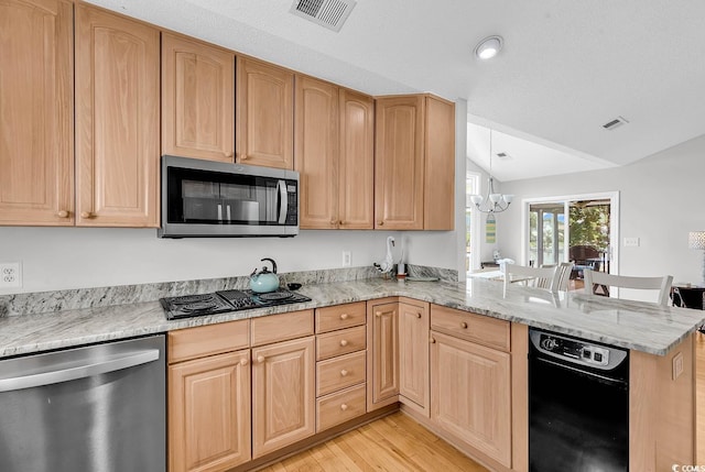 521 Bay Dr, Garden City Beach, SC 29576 - kitchen with stainless steel appliances, lofted ceiling, a chandelier, a peninsula, and light brown cabinetry