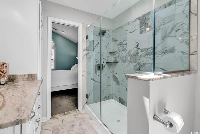 521 Bay Dr, Garden City Beach, SC 29576 - ensuite bathroom featuring a marble finish shower and marble look tile flooring