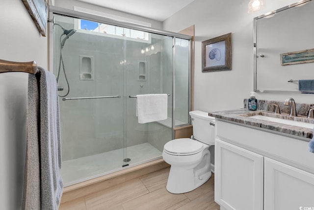521 Bay Dr, Garden City Beach, SC 29576 - bathroom featuring toilet, vanity, a shower stall, and wood finished floors