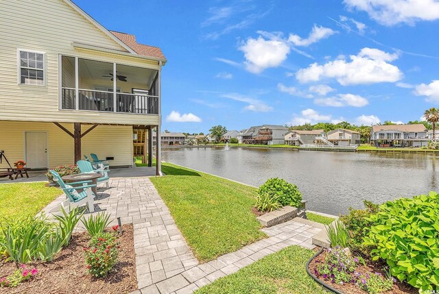 521 Bay Dr, Garden City Beach, SC 29576 - view of grassy yard with a patio area, a water view, a residential view, and a ceiling fan