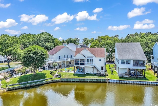 521 Bay Dr, Garden City Beach, SC 29576 - back of property with stairway, a deck with water view, a sunroom, and a patio