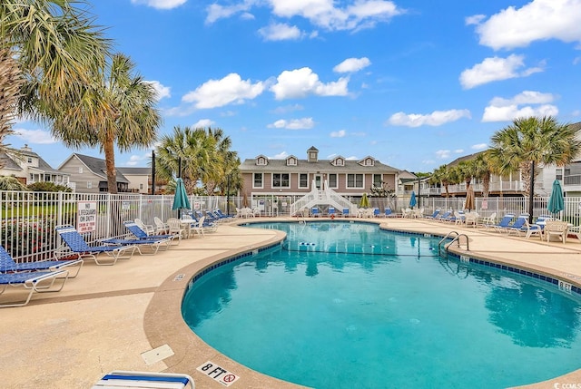 521 Bay Dr, Garden City Beach, SC 29576 - community pool featuring a patio and a residential view