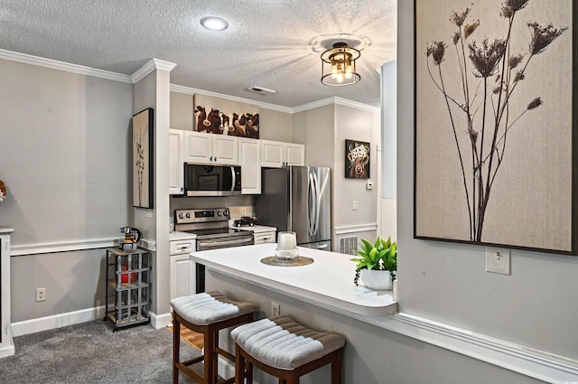 4251 Hibiscus Dr Unit 202, Little River, SC 29566 - kitchen featuring stainless steel appliances, a breakfast bar, white cabinetry, dark carpet, and a textured ceiling