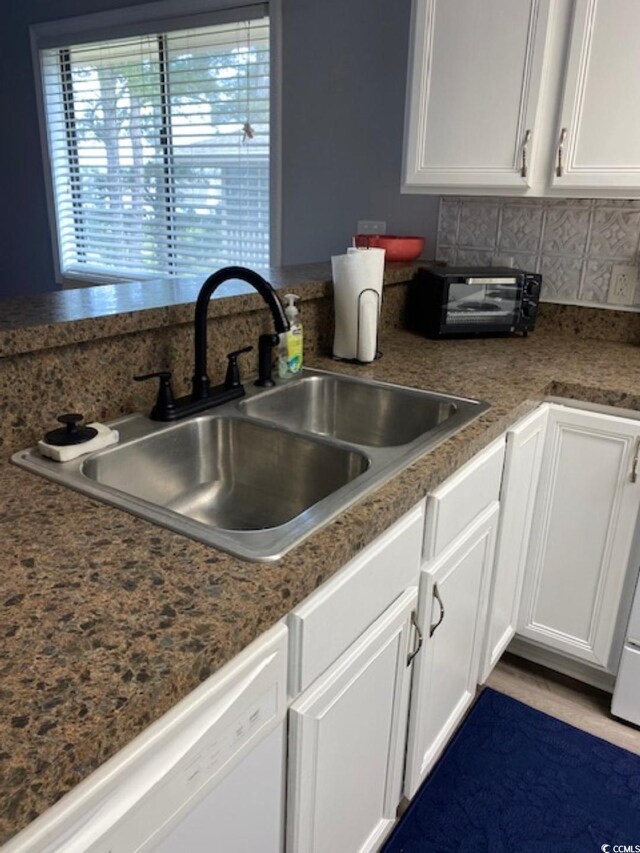 4107 Pinehurst Cir Unit Dd-15, Little River, SC 29566 - kitchen featuring dishwasher, white cabinetry, and decorative backsplash