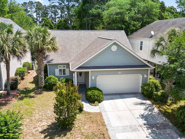 618 5th Ave S, North Myrtle Beach, SC 29582 - view of front of property featuring an attached garage, driveway, and a shingled roof