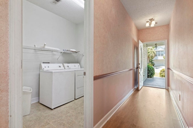 618 5th Ave S, North Myrtle Beach, SC 29582 - washroom with a textured ceiling, washing machine and clothes dryer, and baseboards