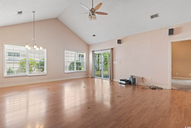 618 5th Ave S, North Myrtle Beach, SC 29582 - unfurnished living room with ceiling fan, light wood-style floors, high vaulted ceiling, a chandelier, and baseboards
