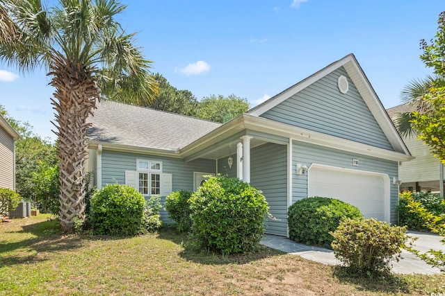 618 5th Ave S, North Myrtle Beach, SC 29582 - view of home's exterior with a garage, cooling unit, a shingled roof, and a yard