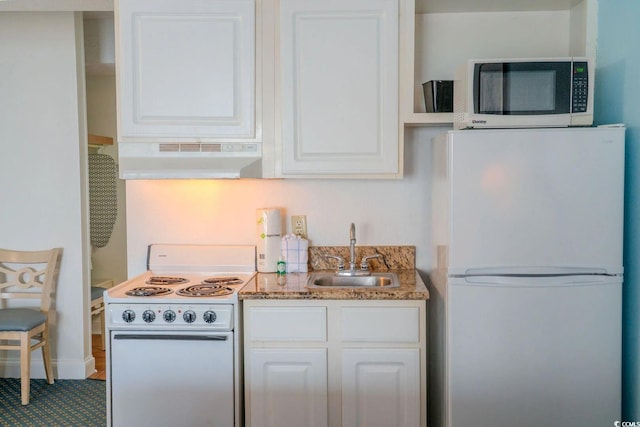 1207 Ocean Blvd S Unit 20802, Myrtle Beach, SC 29577 - kitchen featuring white appliances, under cabinet range hood, a sink, white cabinets, and stone counters