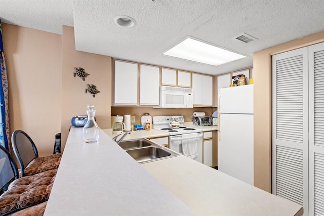 2801 S Ocean Blvd Unit 941, North Myrtle Beach, SC 29582 - kitchen featuring white appliances, a sink, a textured ceiling, light countertops, and white cabinetry