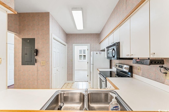 159-1 Weehawka Way Unit 159-1, Pawleys Island, SC 29585 - kitchen featuring electric panel, stainless steel range with electric cooktop, light countertops, a sink, and wallpapered walls