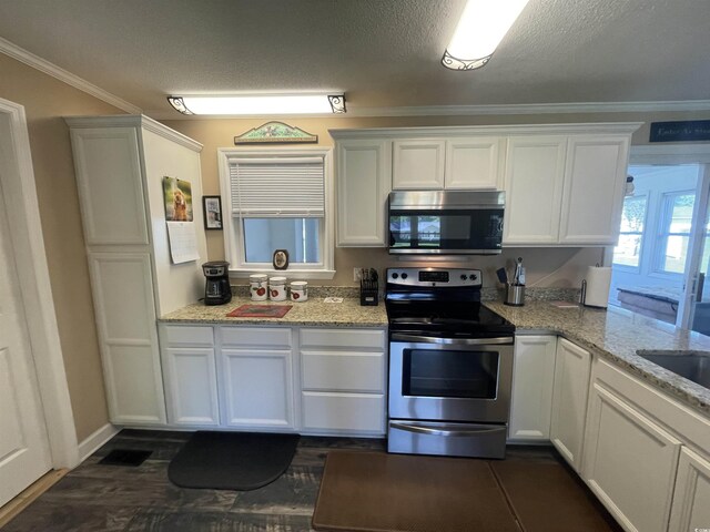 4637 Dogwood St, Loris, SC 29569 - kitchen with appliances with stainless steel finishes, ornamental molding, white cabinetry, light stone countertops, and a textured ceiling