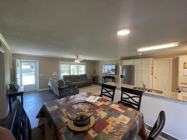 4637 Dogwood St, Loris, SC 29569 - dining room with crown molding, wood finished floors, a textured ceiling, baseboards, and a ceiling fan