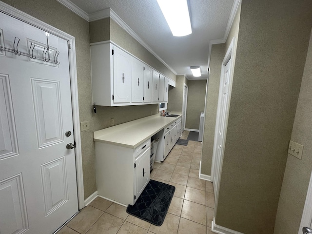 4637 Dogwood St, Loris, SC 29569 - laundry room with ornamental molding, light tile patterned floors, a sink, and baseboards
