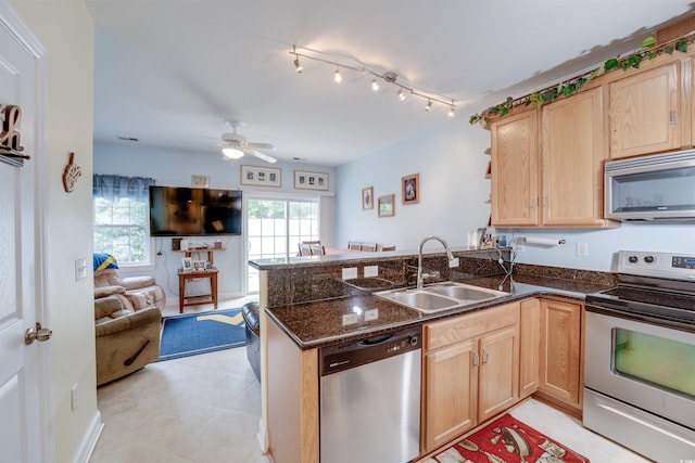 702 Beach Walk Pl Unit 702, Myrtle Beach, SC 29577 - kitchen featuring appliances with stainless steel finishes, a sink, light brown cabinets, open floor plan, and a peninsula