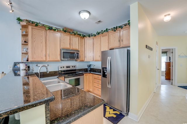 702 Beach Walk Pl Unit 702, Myrtle Beach, SC 29577 - kitchen with stainless steel appliances, light brown cabinets, and a sink