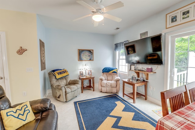 702 Beach Walk Pl Unit 702, Myrtle Beach, SC 29577 - living area featuring healthy amount of natural light, light tile patterned floors, a ceiling fan, and baseboards