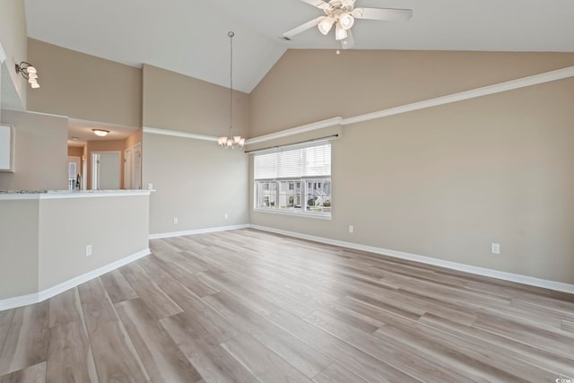 4924 Pond Shoals Ct Unit 201, Myrtle Beach, SC 29579 - unfurnished living room with high vaulted ceiling, a ceiling fan, light wood-type flooring, baseboards, and a chandelier