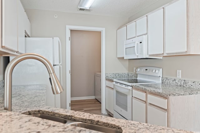4924 Pond Shoals Ct Unit 201, Myrtle Beach, SC 29579 - kitchen with white appliances, light wood-style flooring, light stone counters, a sink, and a textured ceiling