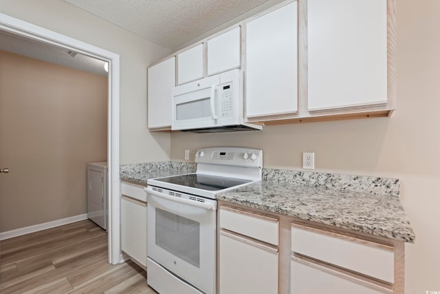 4924 Pond Shoals Ct Unit 201, Myrtle Beach, SC 29579 - kitchen featuring white appliances, light wood finished floors, washing machine and dryer, white cabinetry, and a textured ceiling