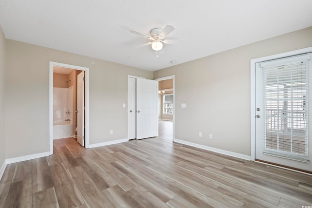 4924 Pond Shoals Ct Unit 201, Myrtle Beach, SC 29579 - unfurnished bedroom featuring baseboards, light wood-style floors, access to outside, connected bathroom, and a ceiling fan