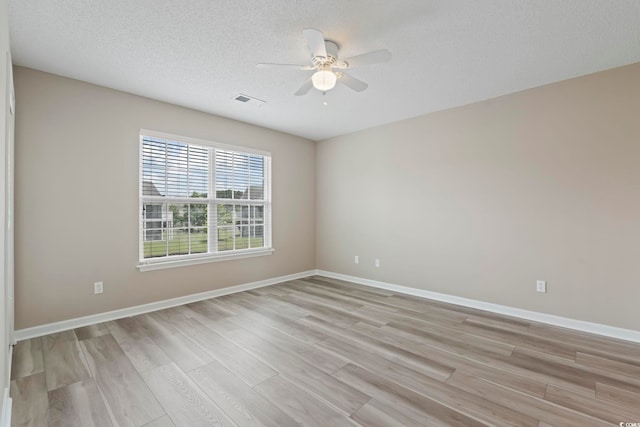 4924 Pond Shoals Ct Unit 201, Myrtle Beach, SC 29579 - empty room with light wood-style flooring, a ceiling fan, baseboards, and a textured ceiling