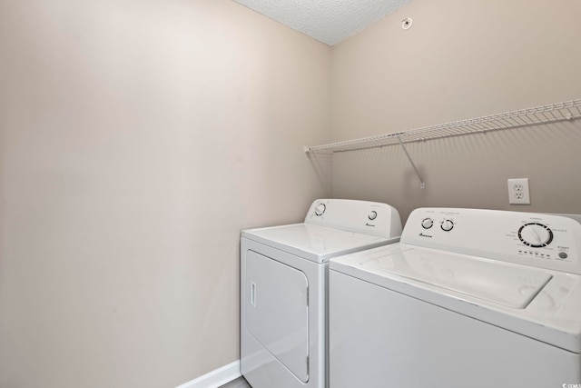 4924 Pond Shoals Ct Unit 201, Myrtle Beach, SC 29579 - washroom with washer and dryer, a textured ceiling, and baseboards
