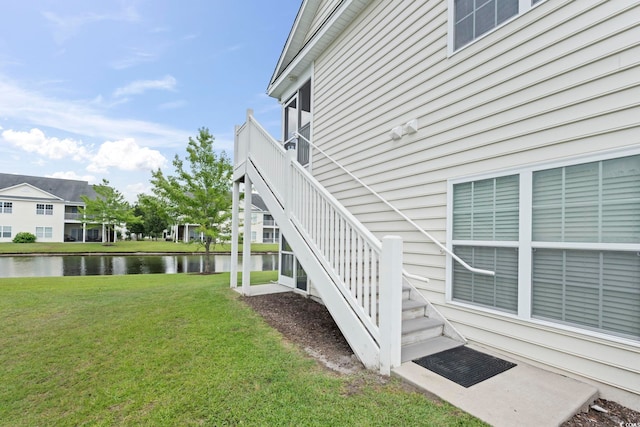 4924 Pond Shoals Ct Unit 201, Myrtle Beach, SC 29579 - view of side of property with a water view, a lawn, and stairs