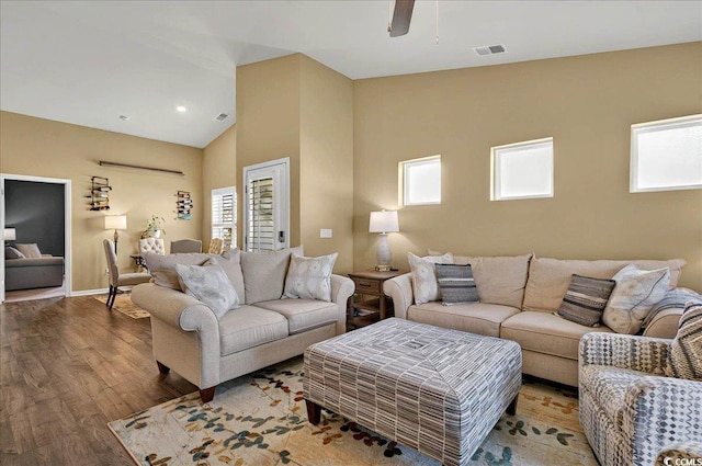 1631 Hepburn Dr, Little River, SC 29566 - living area featuring plenty of natural light, wood finished floors, vaulted ceiling, ceiling fan, and baseboards