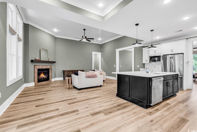 103 Pigeon Forge Ct, Murrells Inlet, SC 29576 - kitchen with a ceiling fan, appliances with stainless steel finishes, dark cabinets, light countertops, and crown molding