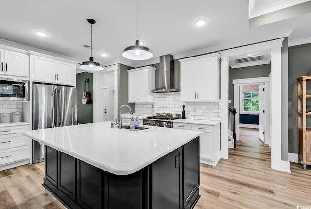 103 Pigeon Forge Ct, Murrells Inlet, SC 29576 - kitchen with appliances with stainless steel finishes, wall chimney exhaust hood, light countertops, decorative backsplash, and light wood-type flooring